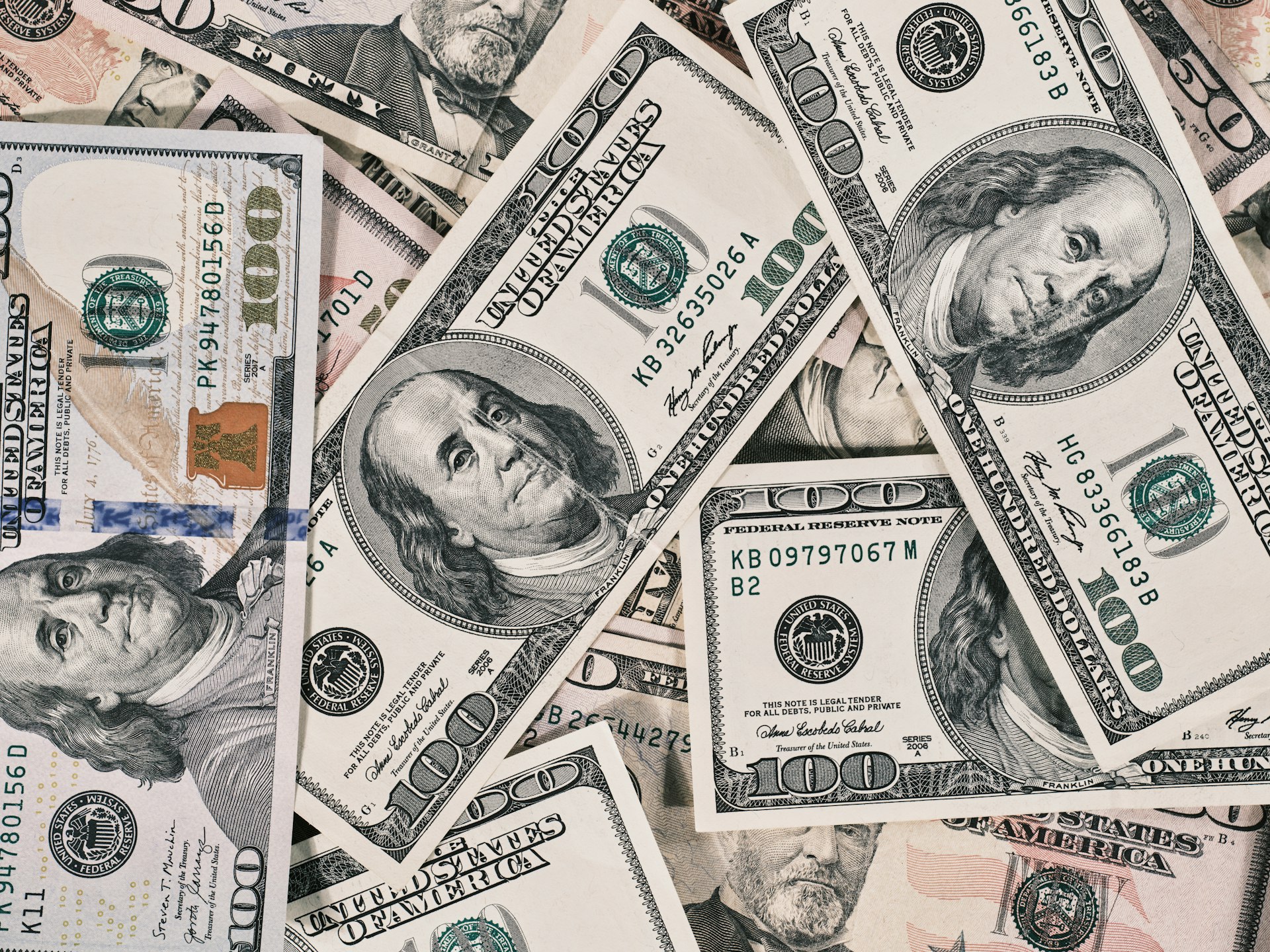 a pile of twenty dollar bills laying on top of each other